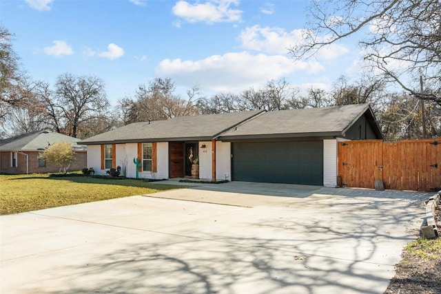 ranch-style house featuring a garage and a front yard