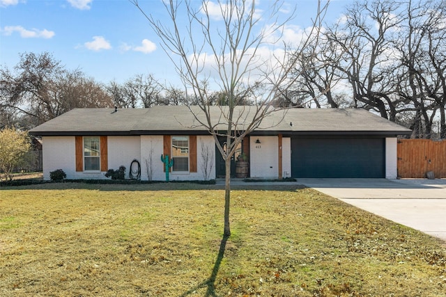 ranch-style home featuring a garage and a front yard