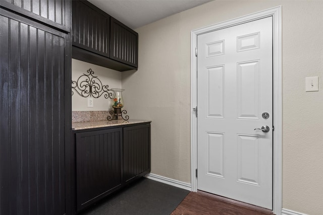 bar with dark hardwood / wood-style floors