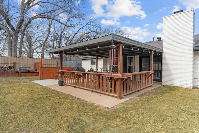 wooden deck featuring a yard and a patio