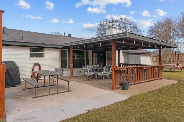 rear view of house featuring a patio and a lawn