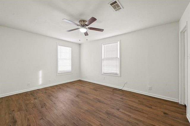 empty room featuring ceiling fan and dark hardwood / wood-style floors