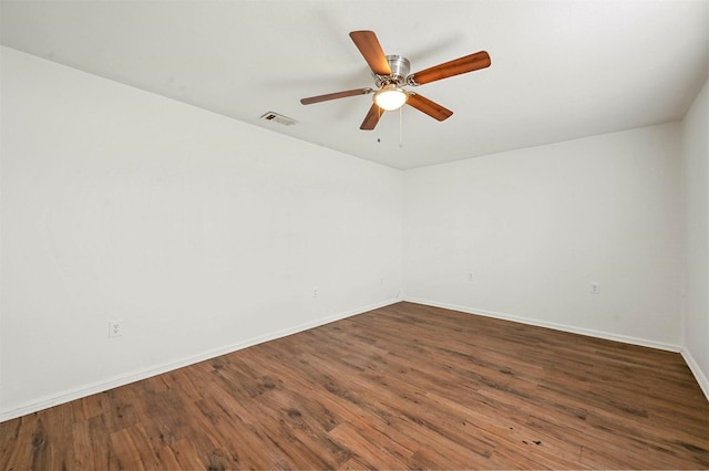 spare room featuring ceiling fan and dark hardwood / wood-style flooring