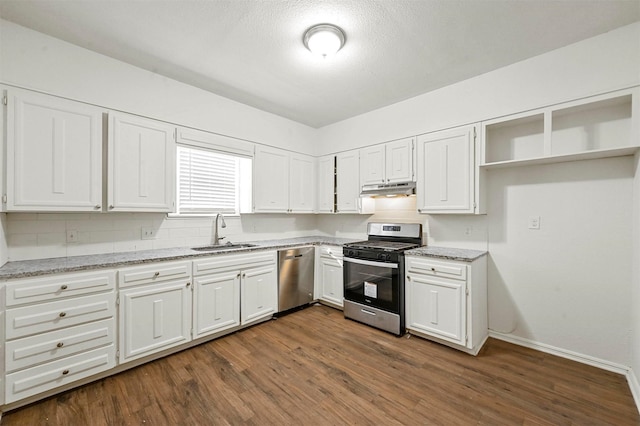 kitchen with appliances with stainless steel finishes, light stone countertops, sink, and white cabinets