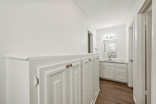 corridor featuring dark hardwood / wood-style flooring and sink