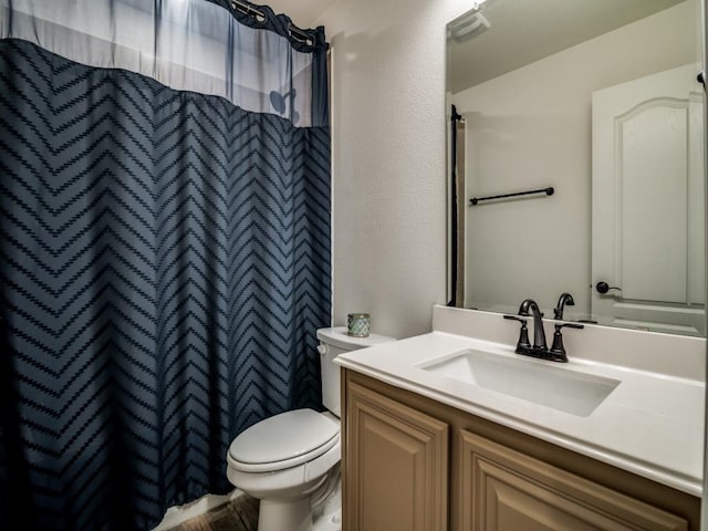 bathroom with vanity, a shower with shower curtain, and toilet