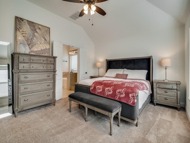 bedroom featuring ceiling fan, connected bathroom, vaulted ceiling, and multiple windows