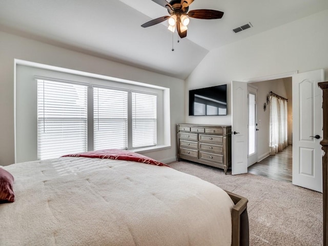 bedroom with ceiling fan, lofted ceiling, and light carpet