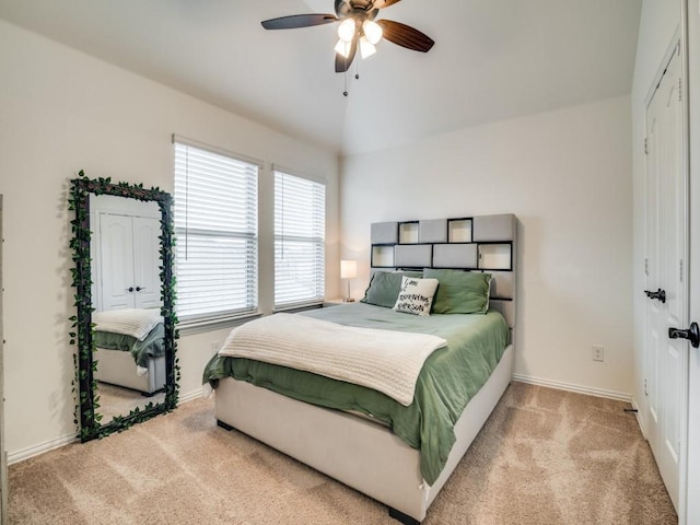 bedroom featuring vaulted ceiling, light colored carpet, and ceiling fan