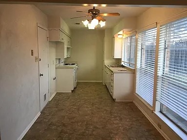 kitchen with ceiling fan, white electric range oven, sink, and white cabinets