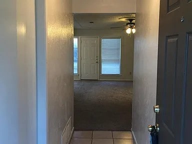 corridor with light tile patterned floors