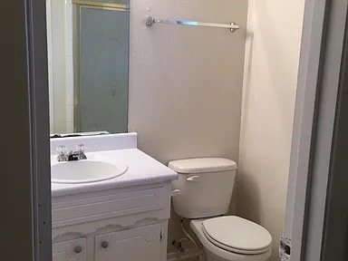 bathroom featuring vanity and toilet