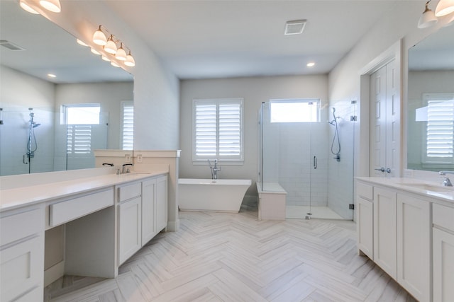 bathroom featuring shower with separate bathtub and vanity