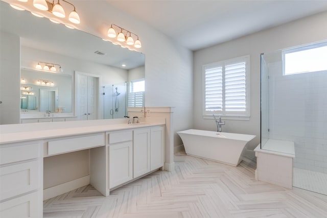 bathroom with vanity, plenty of natural light, and plus walk in shower