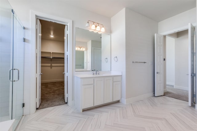 bathroom featuring vanity, parquet floors, and a shower with shower door