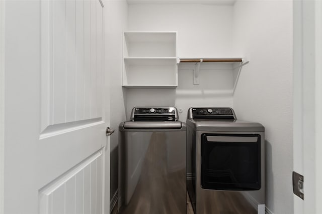 washroom with washing machine and dryer and hardwood / wood-style floors