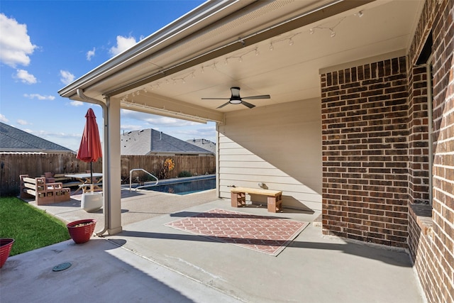 view of patio / terrace featuring a fenced in pool and ceiling fan