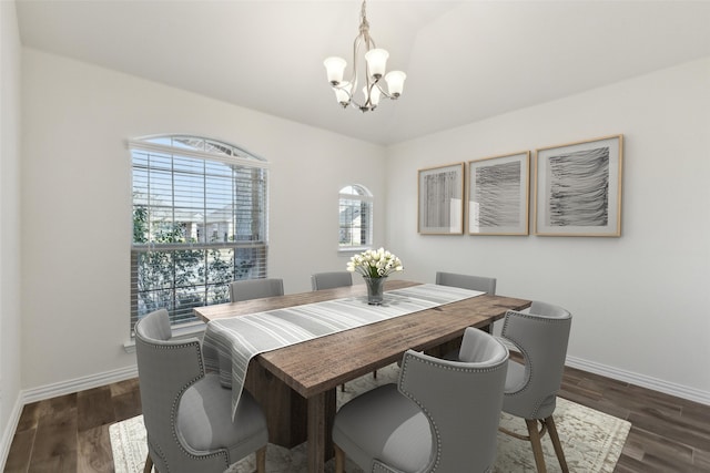 dining room featuring a notable chandelier and dark hardwood / wood-style flooring