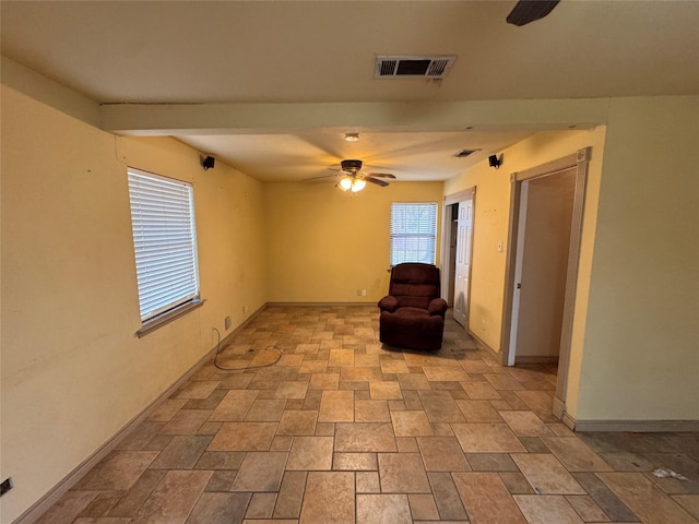 unfurnished room with ceiling fan