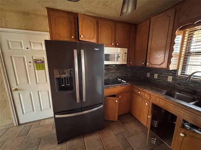 kitchen with sink, backsplash, and black appliances