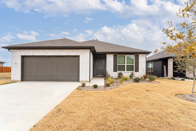 ranch-style home with a garage and a front lawn