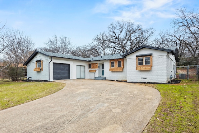 view of front facade featuring a garage, a front lawn, and central air condition unit