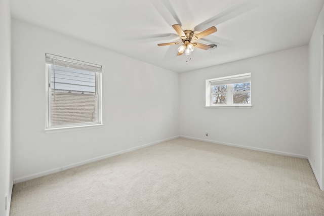 unfurnished room with ceiling fan and carpet flooring