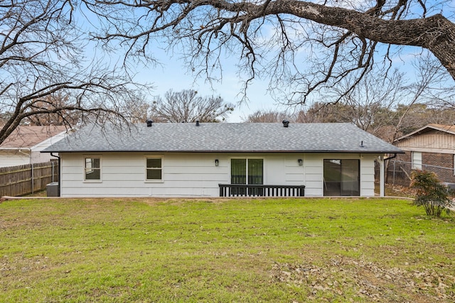 rear view of house featuring a yard