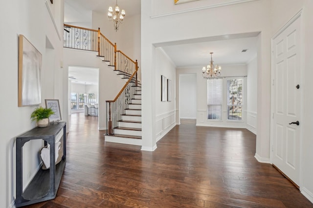 entrance foyer featuring dark hardwood / wood-style flooring, a chandelier, and a wealth of natural light