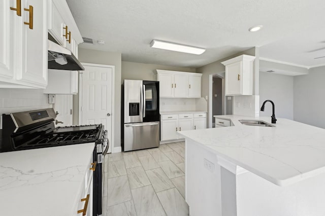 kitchen with sink, appliances with stainless steel finishes, backsplash, white cabinets, and kitchen peninsula