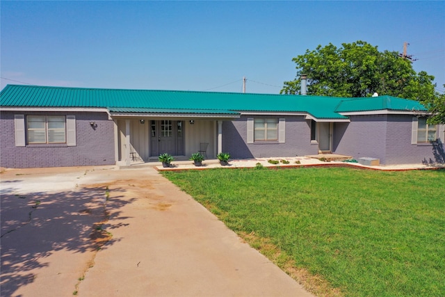 10992 State Highway 6, Avoca, TX 79503 - single story home featuring a front lawn, brick siding, metal roof, board and batten siding, and covered porch