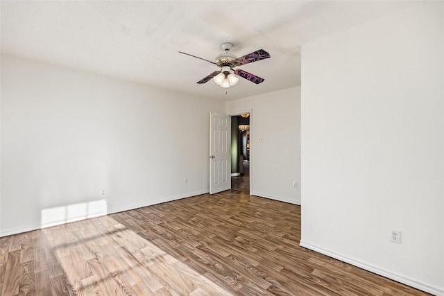 spare room with hardwood / wood-style floors and ceiling fan