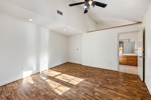 spare room featuring ceiling fan, high vaulted ceiling, light hardwood / wood-style floors, and a textured ceiling