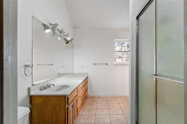 bathroom featuring tile patterned floors, toilet, a shower with shower door, a textured ceiling, and vanity