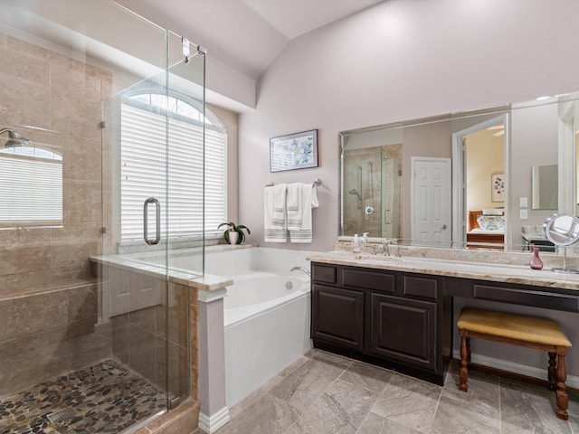 bathroom featuring vaulted ceiling, vanity, and plus walk in shower