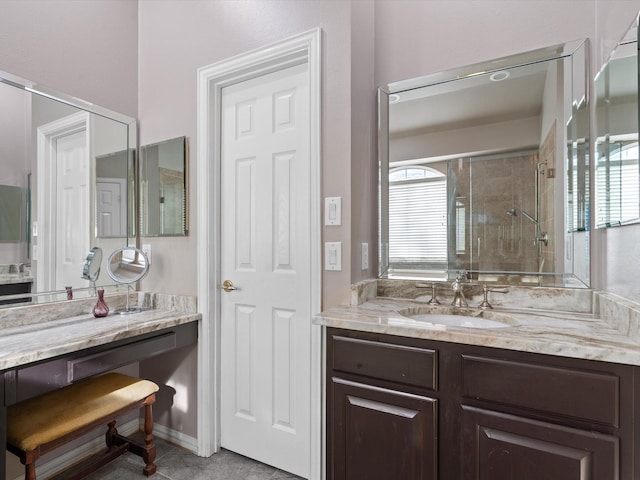 bathroom featuring tile patterned flooring, vanity, a healthy amount of sunlight, and an enclosed shower