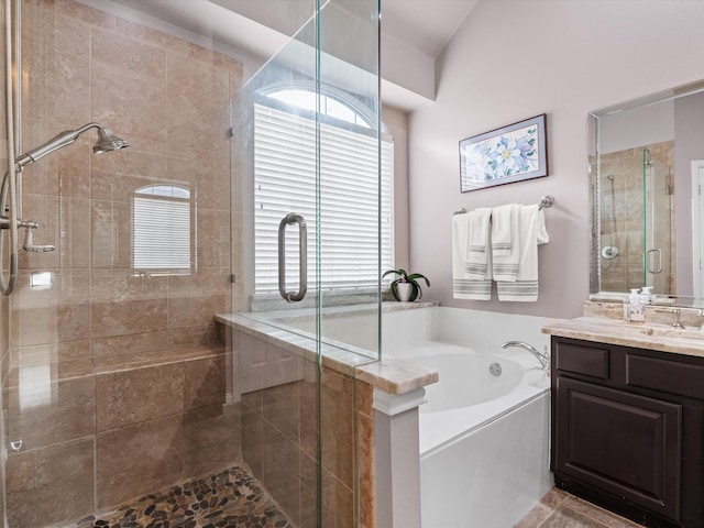 bathroom featuring plus walk in shower and vanity