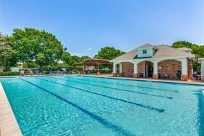 view of swimming pool with an outbuilding