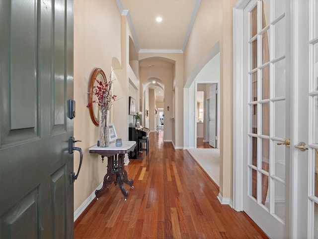 foyer with hardwood / wood-style flooring and crown molding