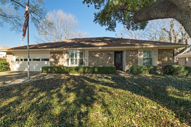 single story home featuring a garage and a front yard