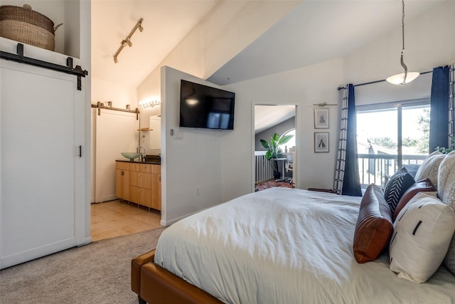 bedroom with sink, a barn door, vaulted ceiling, light carpet, and access to exterior