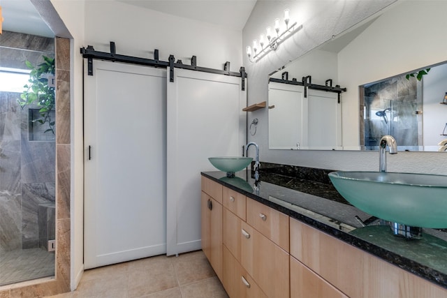 bathroom with vanity, a shower with shower door, and tile patterned flooring