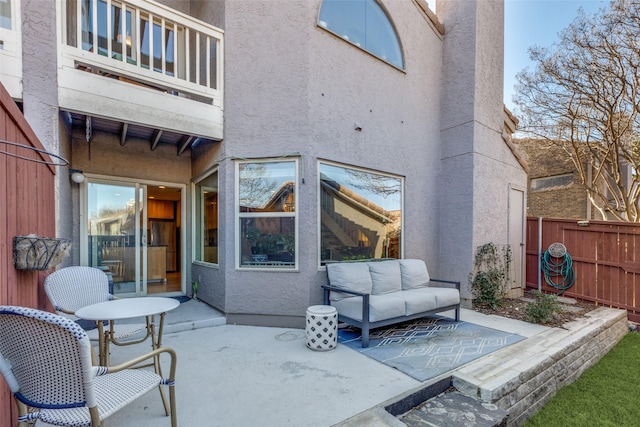 view of patio featuring a balcony and an outdoor hangout area