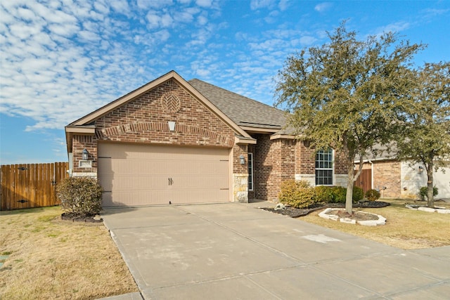 view of front of house featuring a garage and a front lawn