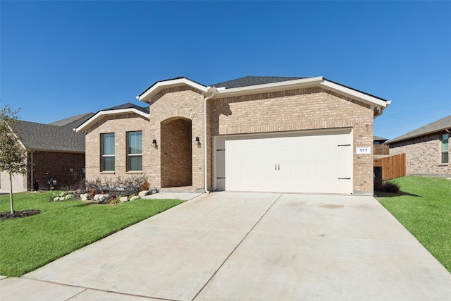 view of front of house with a garage and a front lawn