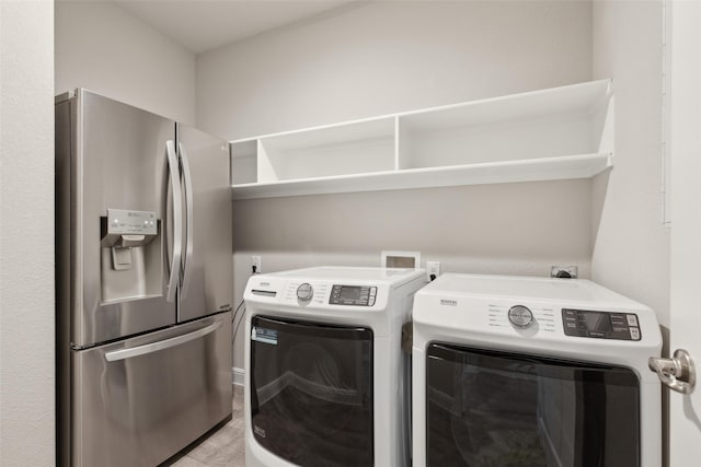 clothes washing area featuring washer and clothes dryer