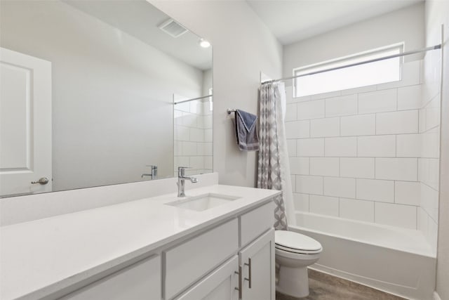 full bathroom featuring vanity, toilet, hardwood / wood-style floors, and shower / bath combo