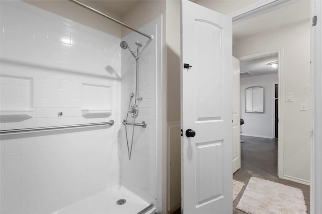 bathroom with tiled shower