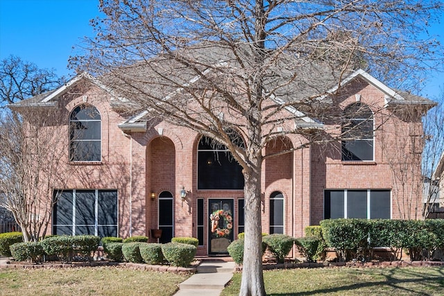 view of property featuring a front lawn