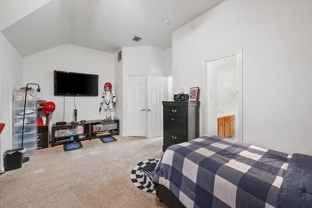 bedroom with light carpet, ensuite bath, and high vaulted ceiling